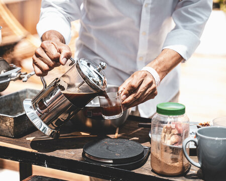 Closeup shot of a gourmet coffee pouring out from a french press