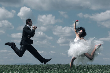 Happy bride and groom jump