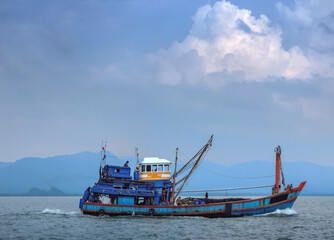 Fishing boat and fishing fleet in action net fishing