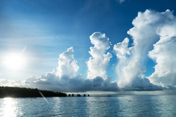 Naklejka na ściany i meble white turbulence cloud with blue sky and the sea nature background