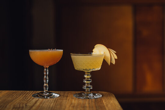 Autumn Fall Cocktails In Fancy Vintage Glassware Against Warm Wood Background