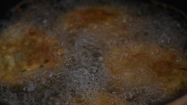 close up of a frying escalopes 
