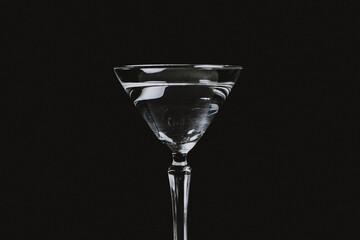 Clear liquor in a martini glass.