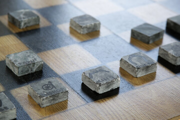 Minimal design stone chess figures on the board