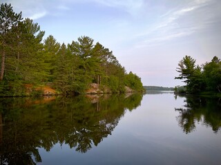River on the lake. Mirror reflection of shoreline 