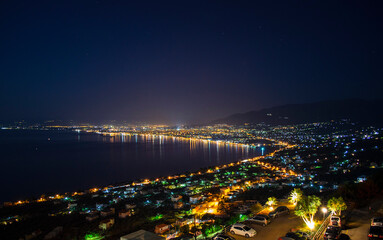 Fototapeta premium Aerial night view of Kalamata city, Greece. Kalamata is one of the most beautiful cities in Greece and a popular tourist destination