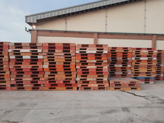 Stacks of colorful industrial plastic pallets