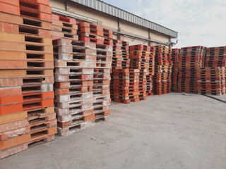 Stacks of colorful industrial plastic pallets