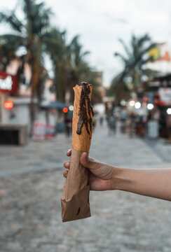 woman's hand holding typical mexican dessert with chocolate - typical foods - marquesitas