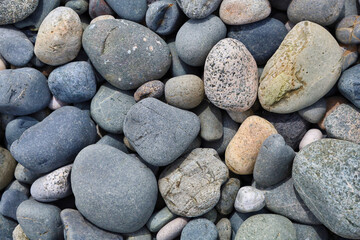 Fototapeta na wymiar Collection of smooth grey rocks worn down by the ocean