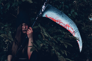 Portrait of woman ghost horror her have scythe on hand, halloween day concept