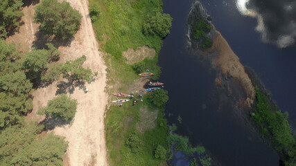 Aerial drone view of group kayak in river. Rafting. Tourist base of kayaks and canoes, summer adventure kayak, rafting to canoe. Kayaking top view