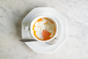 Soft-boiled eggs in white cup