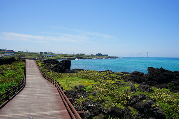 Fototapeta na wymiar a beautiful seaside landscape with walkway and wind power plant