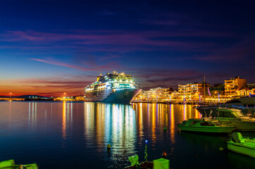 Fototapeta na wymiar Night scenery of a modern cruise ship anchored in the port of Kalamata city, Messenia, Greece.