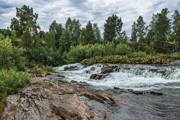 Summer landscape with a waterfall. Western Siberia