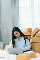 young woman person packing product to a delivery box, female business owner entrepreneur are happy with online e-business at home