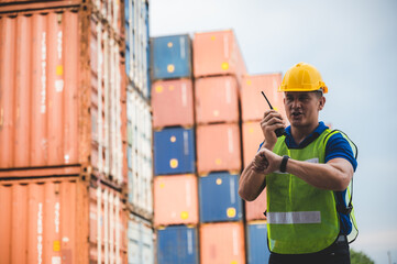 engineer foreman working in container cargo logistic shipping industry for import and export transport, freight business at warehouse port terminal, truck loading control at storage