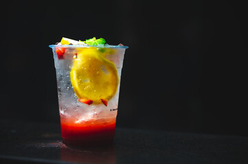 so fresh italian soda top with mint and orange on the table in black dark background, strawberry,...