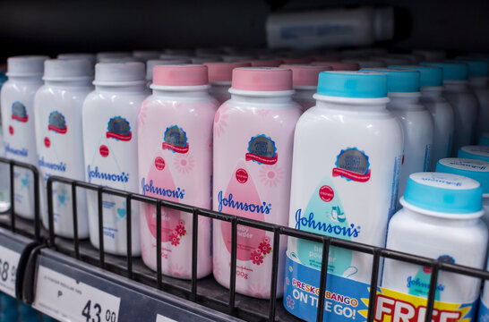 Johnson and Johnson baby powder for sale at an aisle of a supermarket.