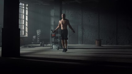 Active guy exercising on jump rope. Energetic man jumping on skipping rope - Powered by Adobe