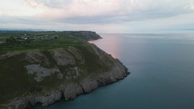 Three Cliffs Bay Beach Limestone Cliffs With Seascape At Sunset In Wales, United Kingdom. - aerial
