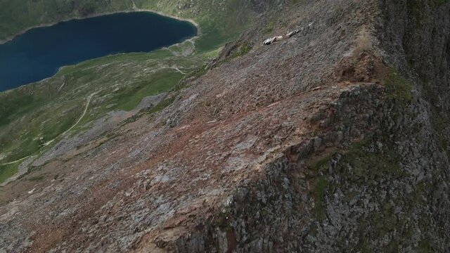 Aerial View Of Llyn Llydaw Lake From Crib Goch "Knife-edged" Arete In Snowdonia National Park in Gwynedd, Wales. - tilt up