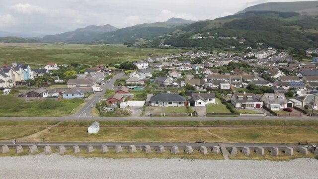 Aerial View Of Seaside Village Of Fairbourne With Snowdonia National Park In Background In Wales, UK. - sideways