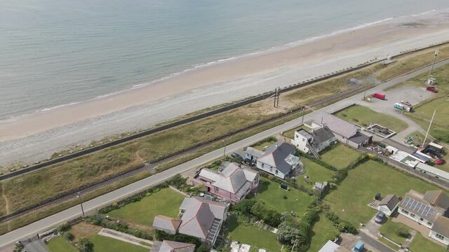 Aerial View Of Holiday Homes Overlooking Seascape And Fairbourne Beach In Summer In Gwynedd, Wales.
