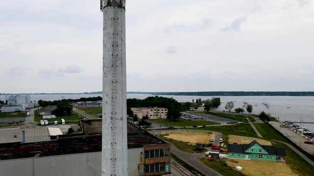 Aerial pan into turn of a rain soaked smoke stack in Muskegon, MI.