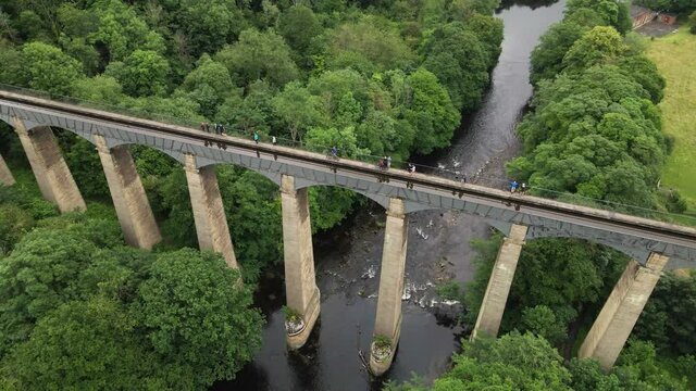 Aerial View Of Tourists Walking On Pontcysyllte Navigable Aqueduct (Traphont Ddwr Pontcysyllte) Across The Dee River In Wales.