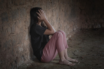 Human trafficking concept.Young girl sitting in old room.teenager girl victims of trafficking.