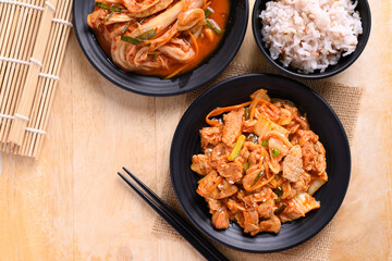 Korean food, Stir-fried kimchi cabbage with pork eating with cooked rice, Table top view