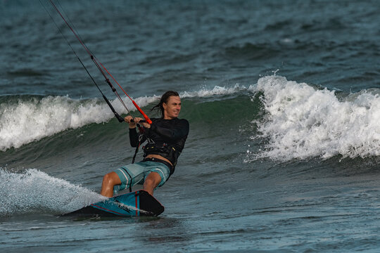 A kite surfer rides the waves