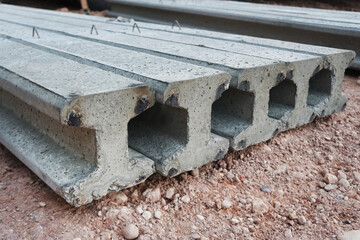 Precast concrete I-beam on ground.