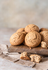 Oatmeal cookies on wooden cutting board, brown concrete background. Healthy snack or dessert.