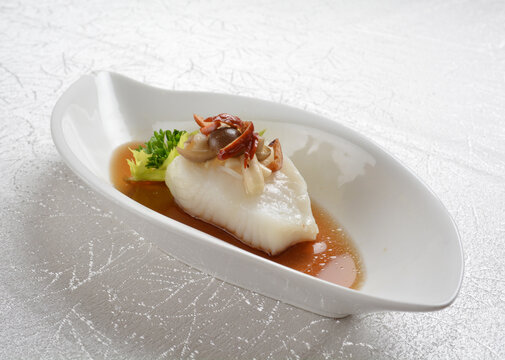 Steamed Fresh Cod Grouper Fish Fillet With Vegetable, Herb And Black Bean Soy Sauce In White Background Asian Halal Seafood Fine Dining Menu