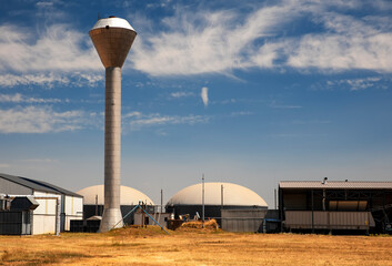 Biogas facility symbol of alternative energy with water tower