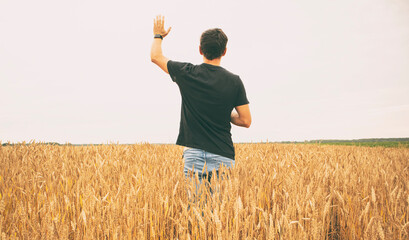 The man praying for the rain in the wheat field