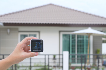 Close-up left hand man who using  PM 2.5  indicator machine equipment for check air visual quality...