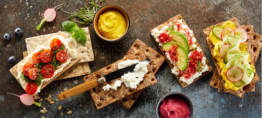 Tasty crispbread toasts placed on table in studio