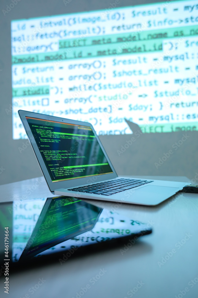 Aufkleber laptop and tablet computer at workplace of hacker in room