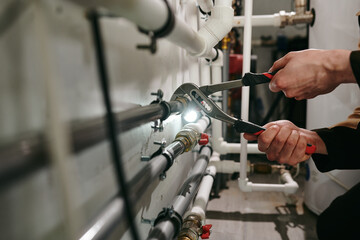 Hands of technician or plumber repairing broken pipes in toilet - Powered by Adobe