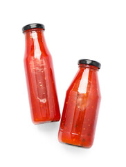 Bottles of chili sauce on white background