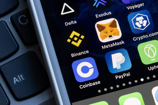 Portland, OR, USA - July 19, 2021: Assorted cryptocurrency apps are seen on an iPhone, including Coinbase, PayPal, Uphold, Binance, MetaMask, Crypto.com, and Delta.