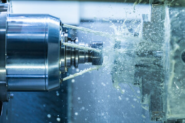Vertical photo of industrial wet milling process with coolant flow under pressure and freezed...