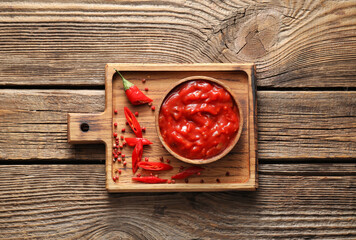 Bowl of tasty salsa sauce on wooden background