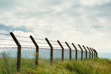 Security fence with razor wire on top