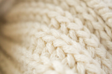 closeup beige knitted woolen fabric background