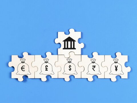 Finance and banking concept on jigsaw puzzle pieces with icons against blue background.